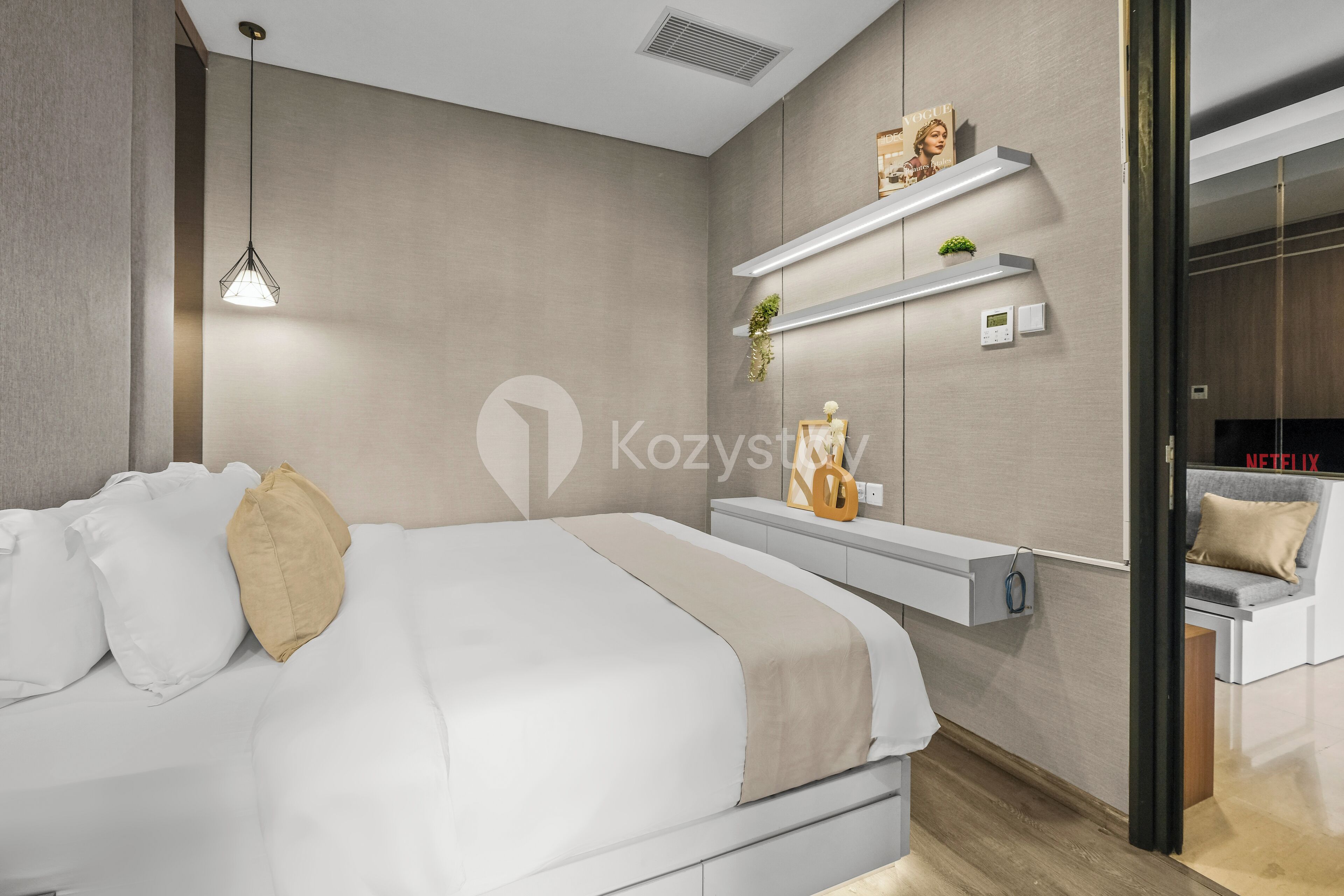 A modern bedroom with a bed, bedside tables, and built-in shelving.