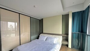 A modern bedroom with a large bed, sliding glass doors, and a city view. - ZHome-Suhe Luxury Mansion-Near the Bund (Shanghai)