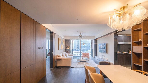 A modern kitchen with a dining area, wooden cabinets, and a large window offering a city view. - ZHome-Luxury Three bedroom Suite (Shanghai)