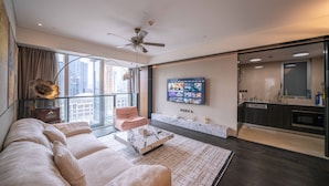 A modern living room with a sofa, coffee table, and a TV mounted on the wall. - ZHome-Luxury Three bedroom Suite (Shanghai)