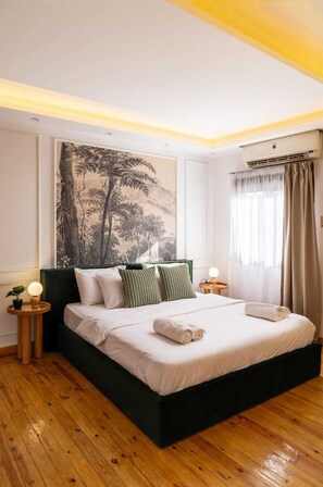 A modern bedroom with a large bed, a wall-mounted air conditioner, and a large window with curtains. - Xuru Stays I The 2 BDR Sterling Residence 5 min to CAI Airport (Cairo)