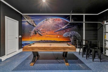 Experience out-of-this-world fun in our sci-fi themed game room with an air hockey table and stunning mural.
