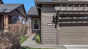 A residential house with a garage, a stone foundation, and a number '863' on the garage door. - New! Old Mill Lookout–Mountain Views, Fireplace, Dog Friendly (Bend)