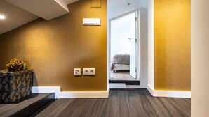 A modern interior with a staircase leading to a bedroom.