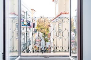 Stroll through the ornate iron gate to discover a charming traditional street scene.