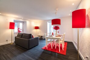 Relax in this stylish living room with a sofa, dining area, and beautiful views.