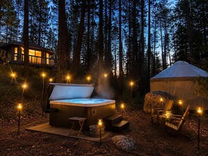 A hot tub in a forest setting with a yurt and a wooden deck. - 1-Acre Forest Sanctuary | Hot Tub | Seasonal Creek (Idyllwild-Pine Cove)