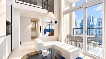 A modern apartment with a living area, kitchen, and dining space.
