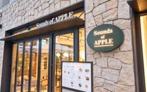 A restaurant named 'Sounds of Apple' with stone facade and menu board outside. - UH FLAT SIGNATURE GANGNAM (Seoul)