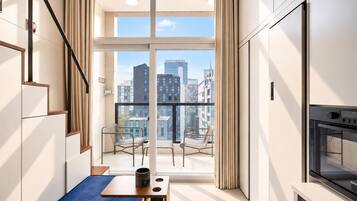 A modern apartment with a balcony, a dining area, and a kitchen.