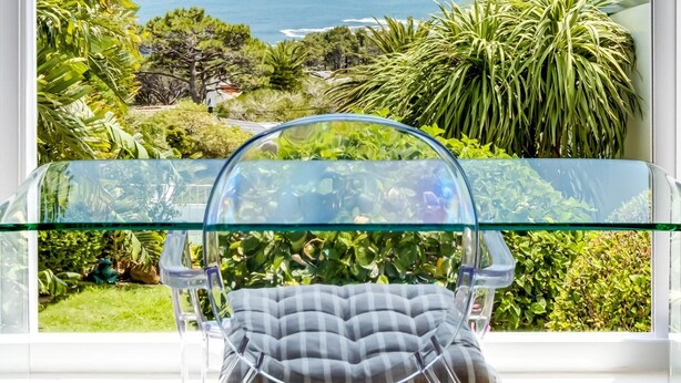 A clear view of the ocean from a balcony with a glass table and chair. - 3bed With Indoor Pool and Sea Views The Sanctuary (Cape Town)