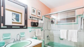 A bathroom with a sink, mirror, toilet, and a glass-enclosed shower. - 4 Mi to Beaches: Vibrant Stuart Villa w/ Patio! (Stuart)
