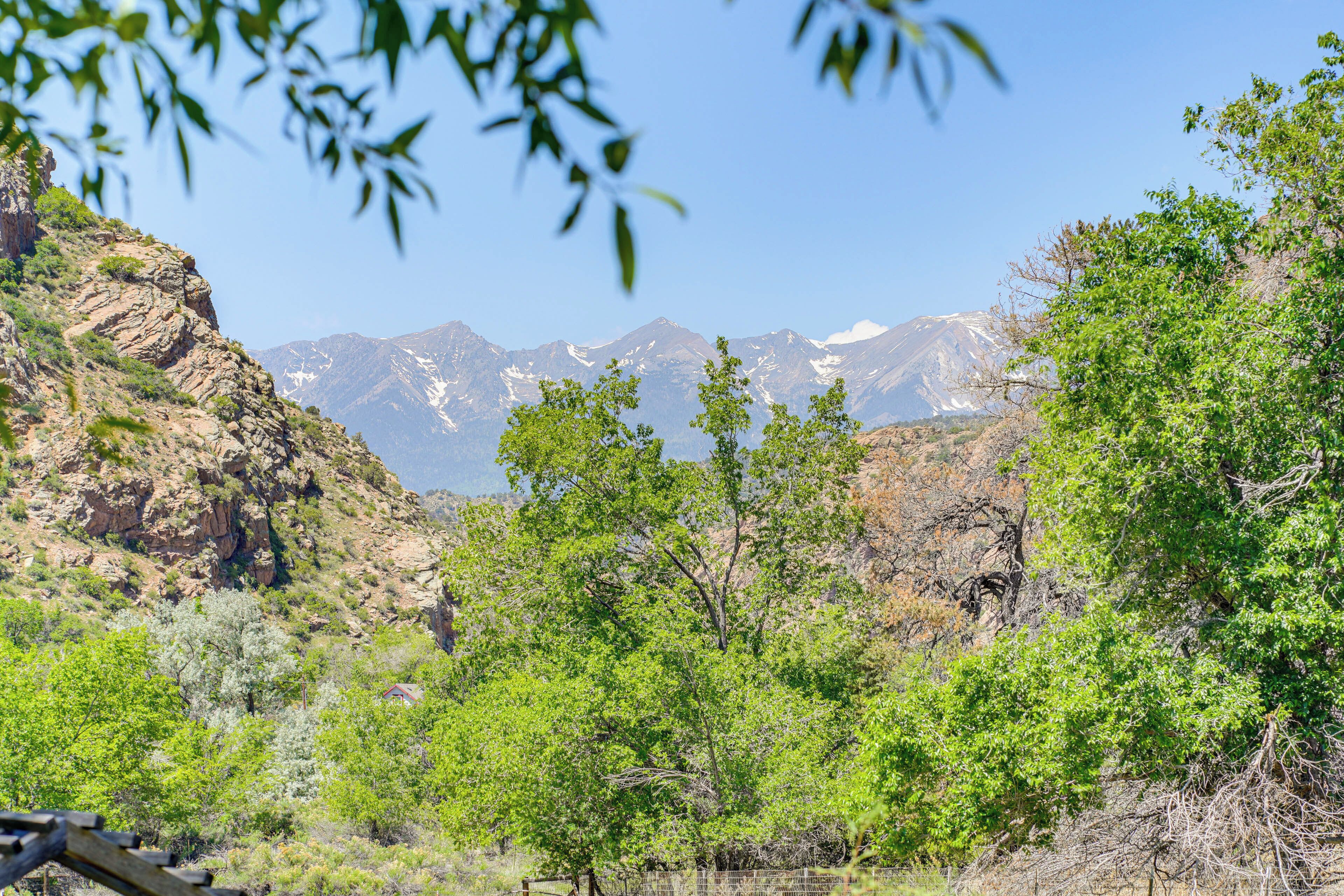 A mountainous landscape with dense green foliage and rocky terrain.