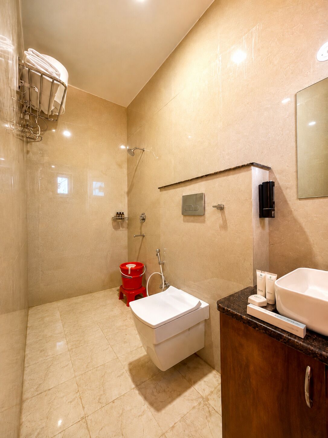 A modern bathroom with a shower, a sink, and a toilet.