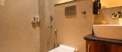 A modern bathroom with a freestanding bathtub, a vanity with a sink, and a shower area.