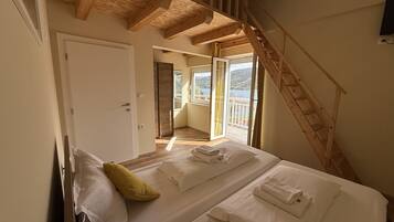 Family Quadruple Room, Courtyard View | Minibar, bed sheets