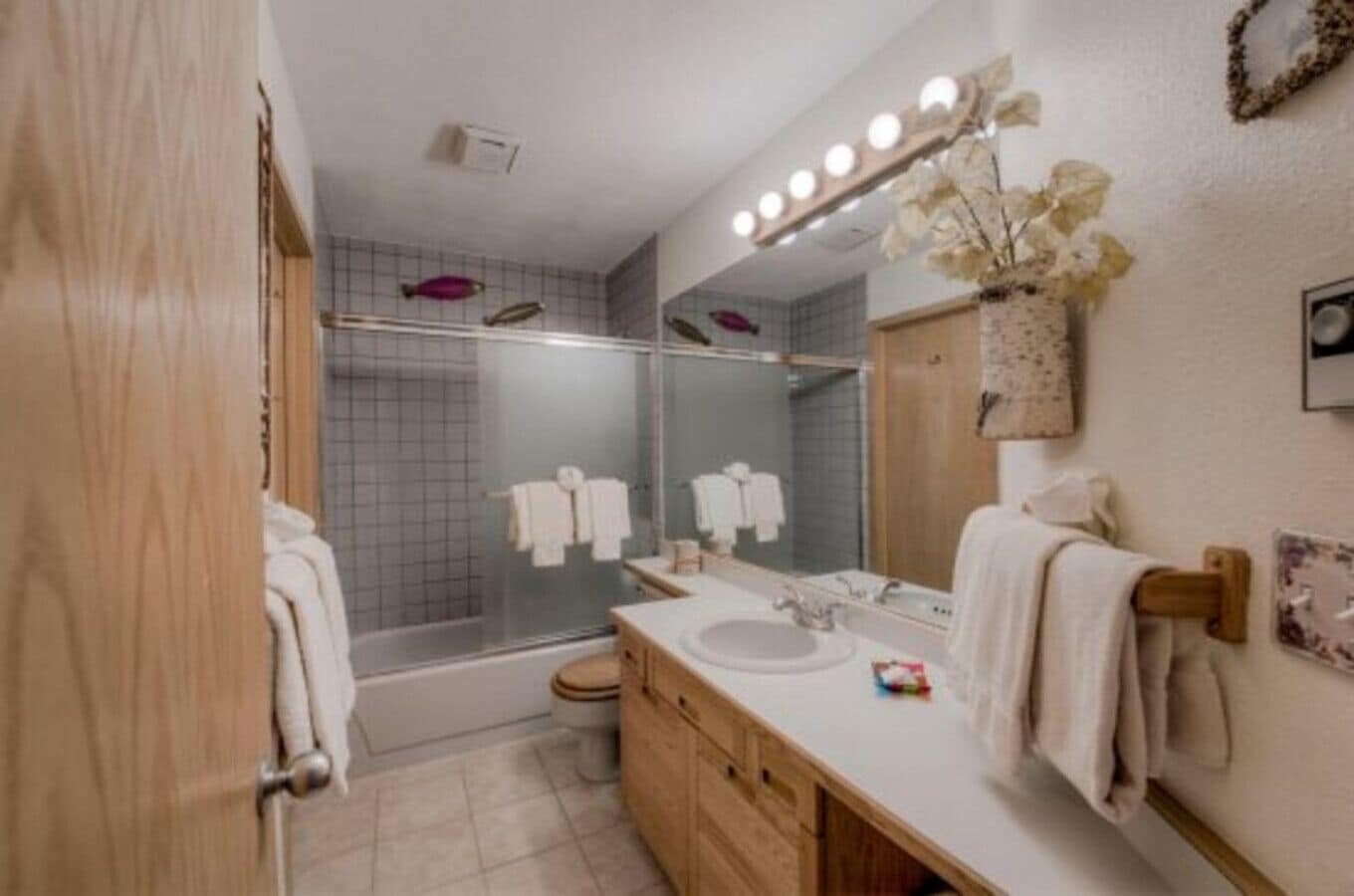 A modern bathroom with a shower, a sink, and a vanity.
