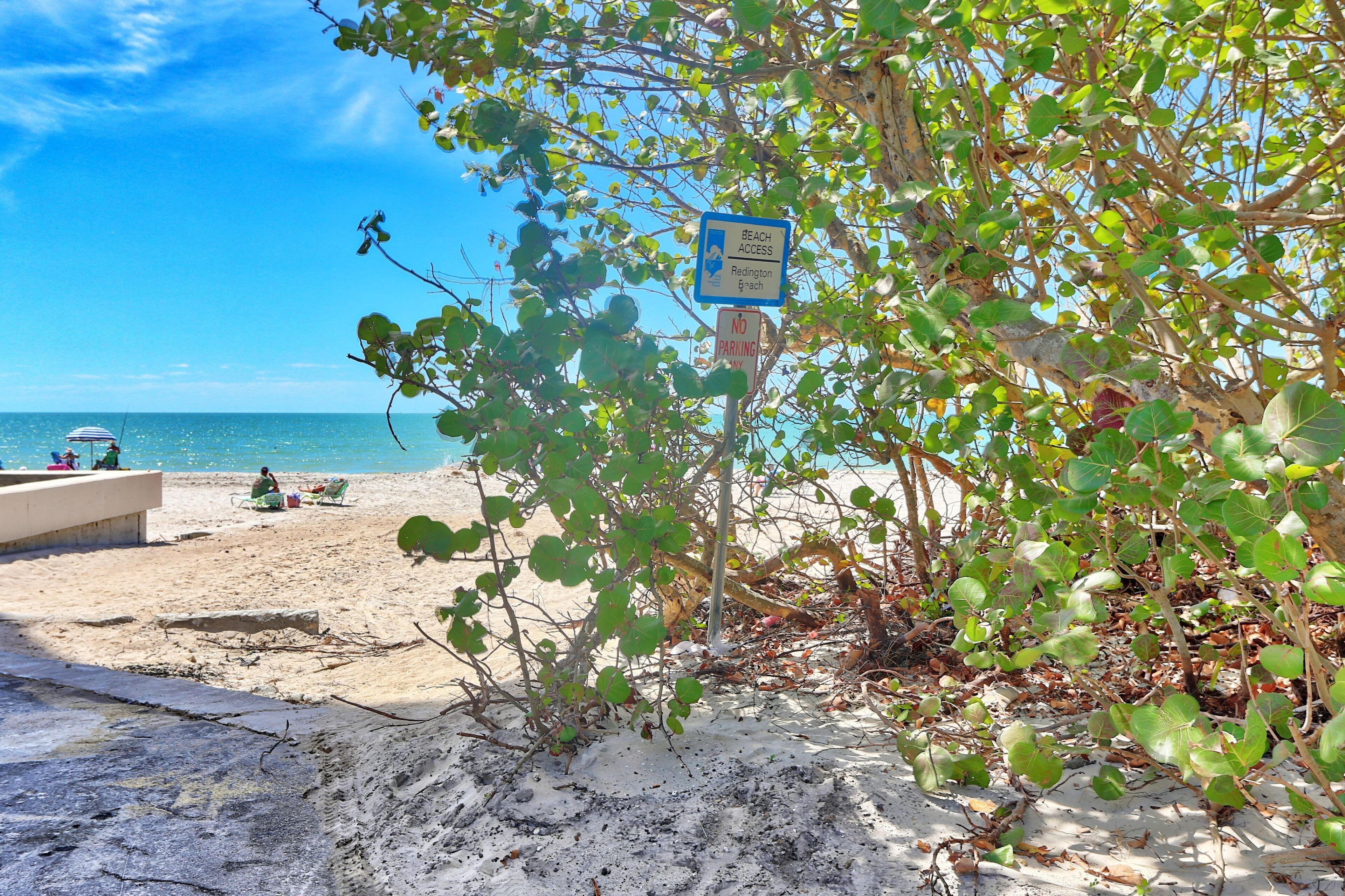 A beach with a sign indicating beach access to Ridlington Beach.