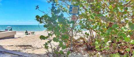 A beach with a sign indicating beach access to Ridlington Beach.