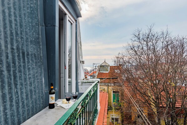 Enjoy a drink on the balcony with a view of the traditional building.