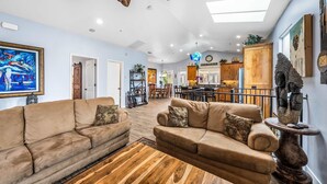 A spacious living room with two beige sofas, a wooden coffee table, and a dining area in the background. - Monterey Home Near Aquarium and Cannery Row (Monterey)