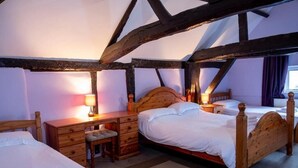 A traditional room with two single beds, a wooden desk, and a chair. - the crown hotel  (Alton)