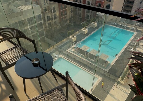 Outdoor pool - EasyGo Stylish 1BDR BinEmrd JVC (Dubai)