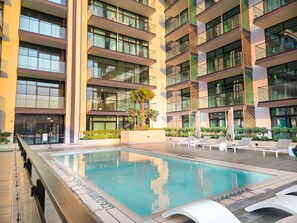 Outdoor pool - EasyGo Stylish 1BDR BinEmrd JVC (Dubai)