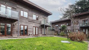 A modern two-story building with large windows and a flat roof. - Treveglos (Truro)