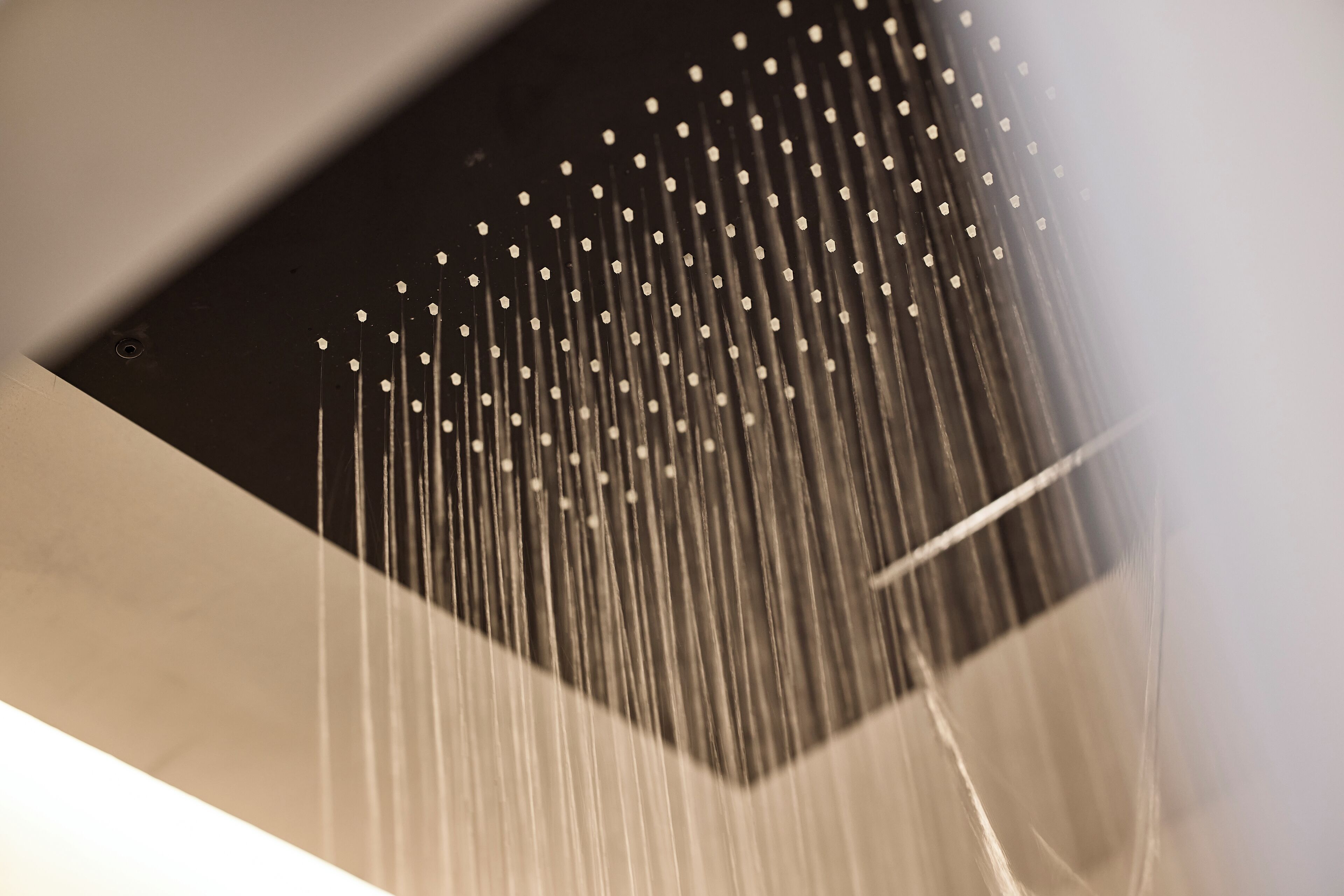 A close-up of a showerhead with multiple water streams.