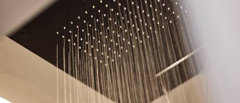 A close-up of a showerhead with multiple water streams.