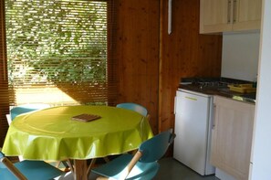 A compact kitchen with a dining area.
