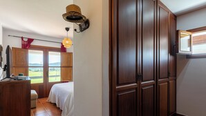 A bedroom with a large window, a bed, a wardrobe, and a desk with a lamp. - New! Villa Cana Vane (Ibiza)