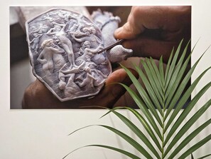 A hand holding a detailed wax seal with intricate designs. - O' Vesuvio B&B (Torre del Greco)