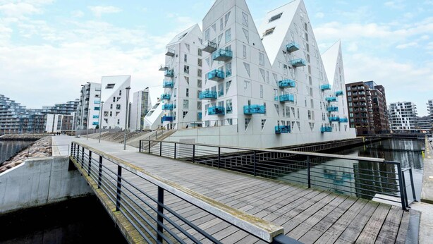 A modern architectural building with a unique triangular design, featuring balconies and a waterfront location. - The Iceberg Residence (Aarhus)