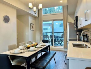 Enjoy meals with family and friends in this spacious dining area, featuring a large table and comfortable seating.