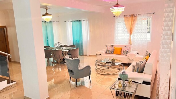 A spacious living area with a dining table, a sofa, and a coffee table. - 3-bedroom villa in nice Tenares with AC, WiFi. Enjoy a relaxing stay , Villa J&R (Tenares)