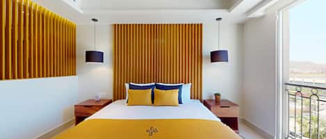 A hotel room with a large bed, two bedside tables, a window with a view, and a wooden panel wall.