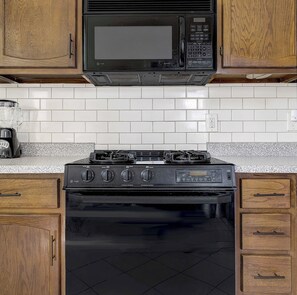 Stove and microwave in kitchen - Historic LoHi Gem | Sauna | Walk to Restaurants (Denver)