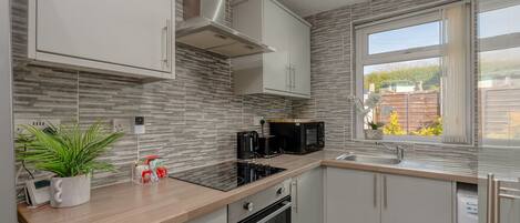 Fridge, microwave, stovetop, coffee/tea maker