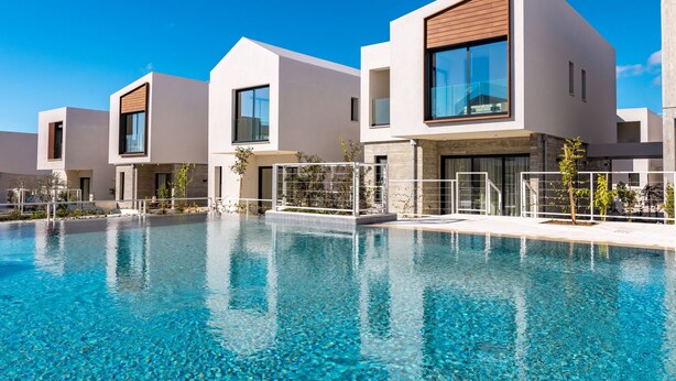 A modern hotel with a swimming pool, featuring contemporary architecture and clear skies. - Avalon Gardens Villa 13 (Emba)