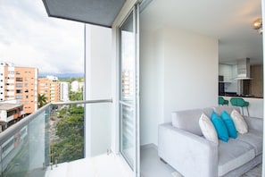Enjoy city views from the balcony with a glass railing, featuring a sliding door to the interior.