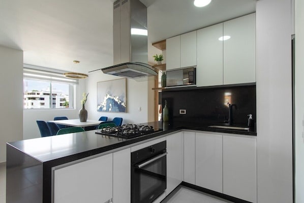 Enjoy cooking in this well-equipped kitchen with a central island, gas stove, and oven.