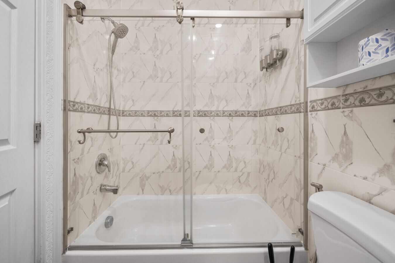 A bathroom with a shower enclosure, a bathtub, and a toilet.