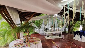 An outdoor wedding venue with a decorated altar, floral arrangements, and a seating area. - Hotel Mar Azul Neiva (Neiva)