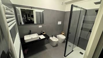 Een douche, een haardroger, een bidet, handdoeken