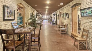 A corridor with brick walls, wooden furniture, and framed pictures. - Brick Haven, 2 bedroom condo in the Grand Traverse Commons (Traverse City)