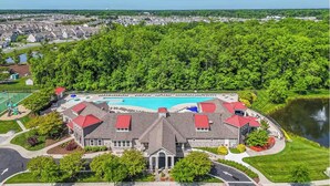 A large building with a swimming pool and a lake.