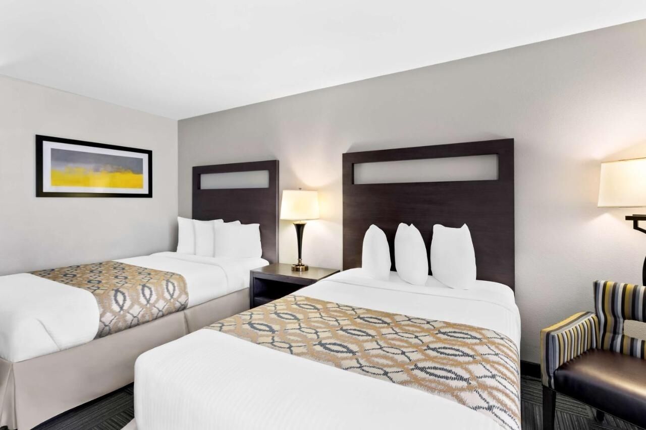 Drift off on plush pillows under warm bedside lighting.