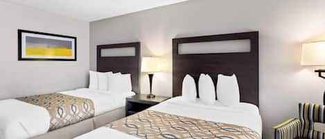Drift off on plush pillows under warm bedside lighting.